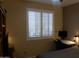 Bedroom with window shutters, workspace, and a bed at 7409 W Briles Rd, Peoria, AZ 85383