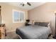 Bright bedroom with a comfortable bed, desk, and window shutters at 7409 W Briles Rd, Peoria, AZ 85383