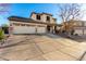 Two-story house with three-car garage and desert landscaping at 7409 W Briles Rd, Peoria, AZ 85383