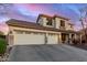 Two-story house with three-car garage and desert landscaping at 7409 W Briles Rd, Peoria, AZ 85383