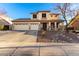 Two-story house with three-car garage and desert landscaping at 7409 W Briles Rd, Peoria, AZ 85383