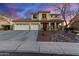 Two-story house with three-car garage, landscaping, and a rock garden at 7409 W Briles Rd, Peoria, AZ 85383