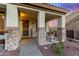 Covered front porch with stone accents and welcoming decor at 7409 W Briles Rd, Peoria, AZ 85383