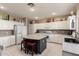 Modern kitchen with white cabinets, granite counters, and an island at 7409 W Briles Rd, Peoria, AZ 85383