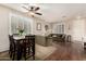 Living room with hardwood floors, comfortable seating, and dining area at 7409 W Briles Rd, Peoria, AZ 85383