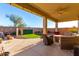 Covered patio with seating area and artificial turf at 7409 W Briles Rd, Peoria, AZ 85383