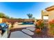 Inviting pool area with a stone pathway and lush landscaping at 7409 W Briles Rd, Peoria, AZ 85383