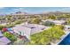 Aerial view of home with tile roof, pool, and mountain backdrop at 7462 E Visao Dr, Scottsdale, AZ 85266