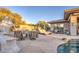 Relaxing stone patio with seating area and fire feature near pool at 7462 E Visao Dr, Scottsdale, AZ 85266