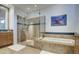 Spa-like bathroom with a glass shower, soaking tub and tiled walls at 7462 E Visao Dr, Scottsdale, AZ 85266