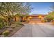 Desert landscaping surrounds this single-story home with a three-car garage at 7462 E Visao Dr, Scottsdale, AZ 85266