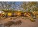 Single-story home with a beautifully landscaped front yard and mature trees at 7462 E Visao Dr, Scottsdale, AZ 85266