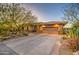 Single-story home with desert landscaping and two-car garage at 7462 E Visao Dr, Scottsdale, AZ 85266