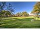 Expansive green space with mature trees and a stone seating area at 7462 E Visao Dr, Scottsdale, AZ 85266