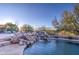 Inviting pool area with a waterfall and plenty of seating at 7462 E Visao Dr, Scottsdale, AZ 85266