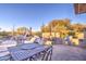 Spacious patio with dining area, grill, and fire pit near pool at 7462 E Visao Dr, Scottsdale, AZ 85266