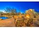 Expansive pool with a built-in fire pit and comfortable seating at 7462 E Visao Dr, Scottsdale, AZ 85266