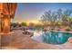 Inviting pool area with a waterfall feature and sunset views at 7462 E Visao Dr, Scottsdale, AZ 85266