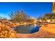 Tranquil pool area with a natural waterfall feature and relaxing ambiance at 7462 E Visao Dr, Scottsdale, AZ 85266