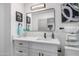 Modern bathroom with white vanity, marble shower, and black accents at 7749 E Coolidge St, Scottsdale, AZ 85251