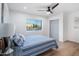 Bright bedroom featuring a blue striped comforter and wood flooring at 7749 E Coolidge St, Scottsdale, AZ 85251