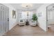 Bright and airy entryway with two comfortable armchairs at 7749 E Coolidge St, Scottsdale, AZ 85251