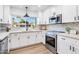 Updated kitchen featuring white shaker cabinets and stainless steel appliances at 7749 E Coolidge St, Scottsdale, AZ 85251