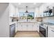 Modern white kitchen with stainless steel appliances and subway tile backsplash at 7749 E Coolidge St, Scottsdale, AZ 85251