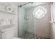 Shower with glass enclosure, pebble floor, and decorative window at 7800 E Lincoln Dr # 1096, Scottsdale, AZ 85250