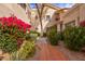 Attractive courtyard entry with red flowers and a brick pathway at 7800 E Lincoln Dr # 1096, Scottsdale, AZ 85250