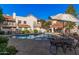 Community pool with patio furniture and umbrellas at 7800 E Lincoln Dr # 2092, Scottsdale, AZ 85250