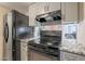 Kitchen with granite countertops and black stove top at 8225 N 34Th Dr, Phoenix, AZ 85051