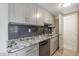 Modern kitchen with granite countertops and gray cabinets at 8225 N 34Th Dr, Phoenix, AZ 85051