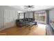 Living room with gray sectional, wood floors, and sliding glass doors to patio at 8225 N 34Th Dr, Phoenix, AZ 85051