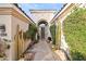 Elegant entryway with lush landscaping and a charming walkway at 8260 E Mohawk Ln, Scottsdale, AZ 85255