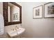 Elegant powder room with a pedestal sink and decorative art at 8260 E Mohawk Ln, Scottsdale, AZ 85255