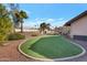 Landscaped backyard with artificial turf and trees at 859 N 54Th Cir, Mesa, AZ 85205