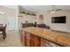 Island kitchen with granite countertops overlooks the living room at 859 N 54Th Cir, Mesa, AZ 85205