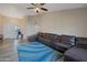 Spacious living room featuring a large sectional sofa and a calming blue rug at 859 N 54Th Cir, Mesa, AZ 85205