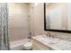 Bathroom with granite vanity and geometric shower curtain at 9270 E Thompson Peak Pkwy # 335, Scottsdale, AZ 85255