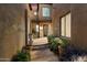 Charming courtyard entry with lush landscaping and stone pathway at 9270 E Thompson Peak Pkwy # 335, Scottsdale, AZ 85255