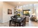 Open concept dining area with modern chandelier and adjacent living room at 9270 E Thompson Peak Pkwy # 335, Scottsdale, AZ 85255