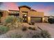 Stunning desert home exterior at sunset, featuring a two-car garage and beautiful landscaping at 9270 E Thompson Peak Pkwy # 335, Scottsdale, AZ 85255