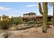 Backyard view of a two-story house with desert landscaping at 9270 E Thompson Peak Pkwy # 335, Scottsdale, AZ 85255