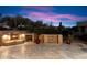 Evening view of a backyard patio with a fireplace and water feature at 9270 E Thompson Peak Pkwy # 335, Scottsdale, AZ 85255