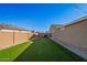 Artificial turf backyard with walkway and wall at 9316 S 39Th Dr, Laveen, AZ 85339