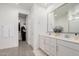 Double vanity bathroom with gray flooring and a walk in closet at 9316 S 39Th Dr, Laveen, AZ 85339