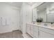 Double vanity bathroom with gray flooring and a view into the shower at 9316 S 39Th Dr, Laveen, AZ 85339