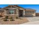 Single-story home with neutral exterior, two-car garage, and landscaping at 9316 S 39Th Dr, Laveen, AZ 85339