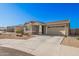 Single-story home with neutral exterior, two-car garage, and landscaping at 9316 S 39Th Dr, Laveen, AZ 85339